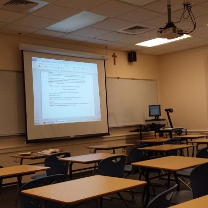 Classroom with projection on front wall and lectern in corner