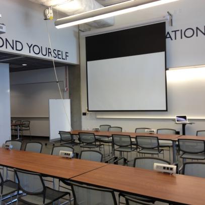 movable seating projection screen at front of room