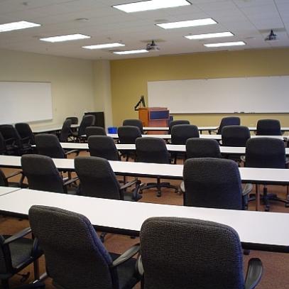 Image of front of classroom with whiteboards