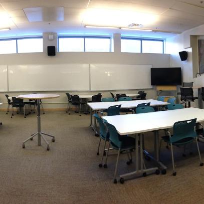 Panaramic of tables and chairs with whiteboards