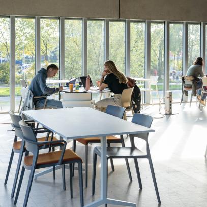 image of transitional space with tables and a glass wall