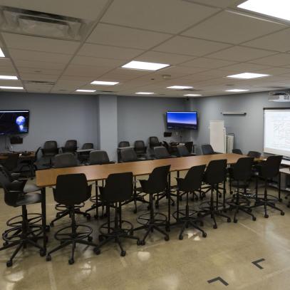 Long table with bar height chairs, multiple displays