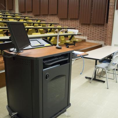 Lectern and table on stage with auditorium seating in background