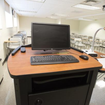 Lectern with classroom seats in background