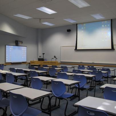 View from back of classroom with projection and whiteboards