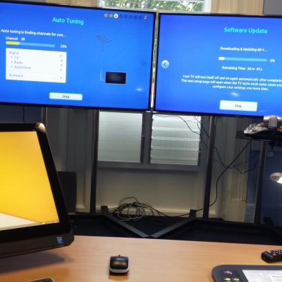 Image of monitors in background and monitor on lectern in foreground