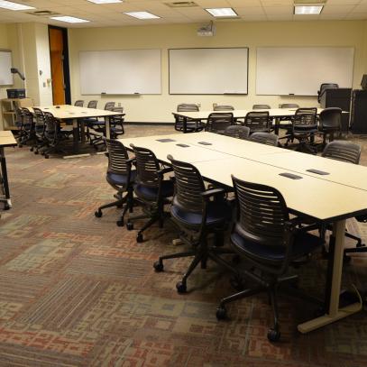 Group tables of 8 with whiteboards around the room