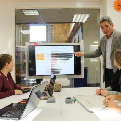 Students around a table with a display