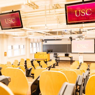 2 monitors from ceiling one projection screen in auditorium seating classroom